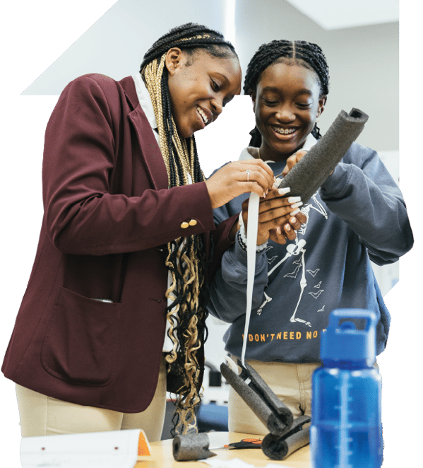 Two PLTW students collaborating on hands-on STEM activity