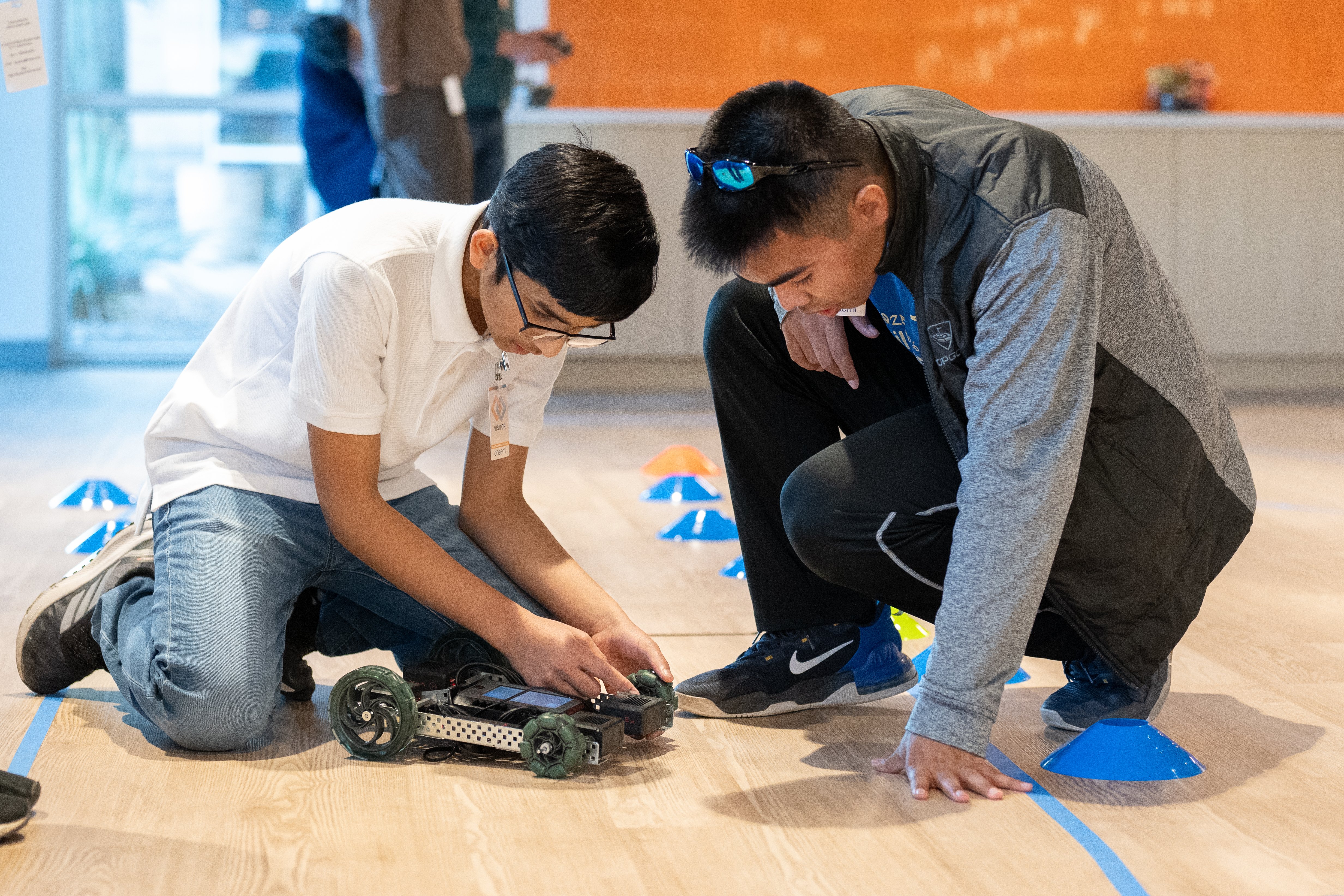 A PLTW Engineering student and teacher focus on adjusting the RC car they designed during Race Day w…
