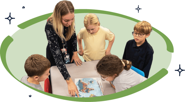 Teacher leading small group of elementary students in hands-on STEM lesson