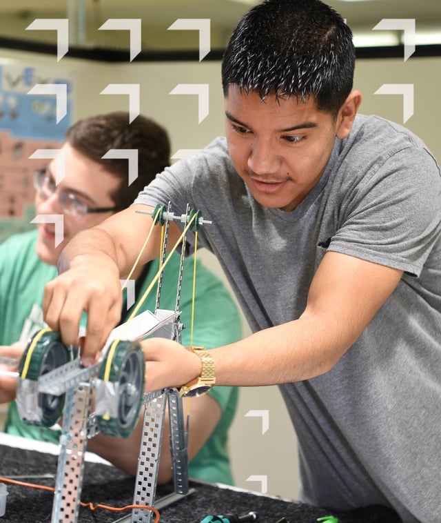 Male PLTW Engineering Student portrait with wayfinder logo background accent