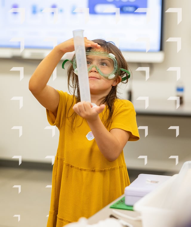 Female PLTW Launch Elementary student wearing lab goggles and user beakers