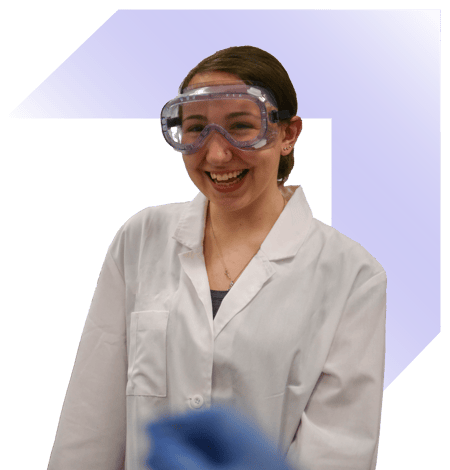 Female PLTW Biomedical Sciences student in lab gear and lab coat