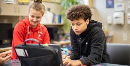 PLTW students working on a computer