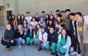 A group of biomedical students poses for a photo during an event led by the ASA and PLTW. 