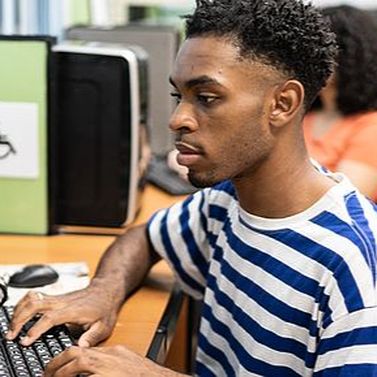 PLTW Student in school computer lab