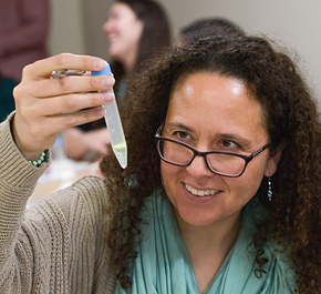 A PLTW Teacher holding up a test tube