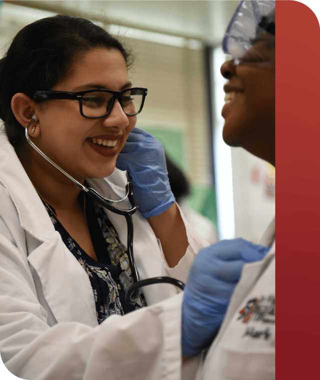 Two PLTW students with a stethoscope