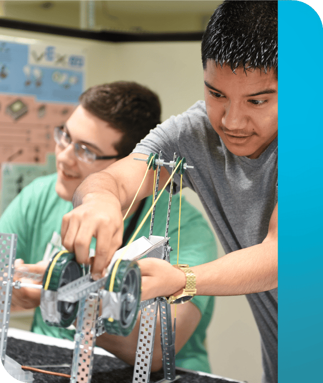 Two PLTW Engineering students building equipment