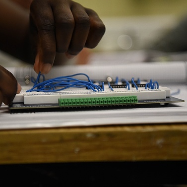 Detail of student’s hands tinkering