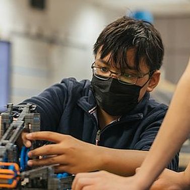 PLTW Gateway student tinkering with robotics kit