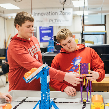 Two PLTW students engaged in a hands on activity