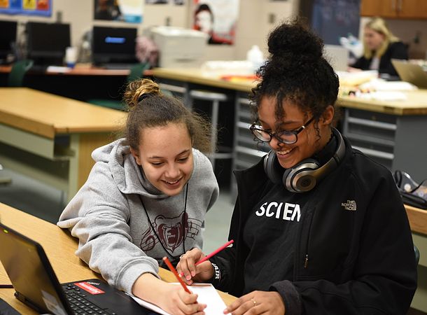 Two PLTW students working together in front of a laptop