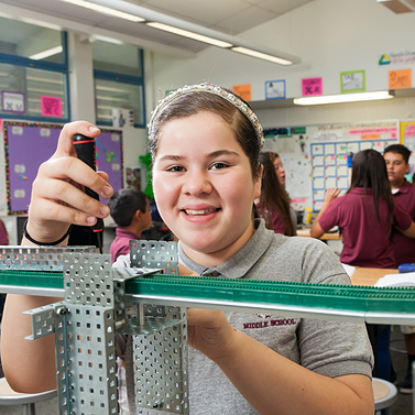 PLTW student using equipment 