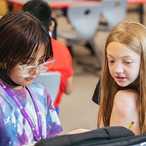 PLTW kids focusing on laptop