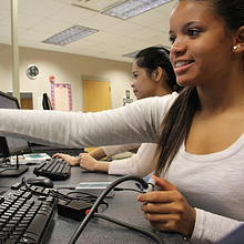 computer science student pointing at screen 